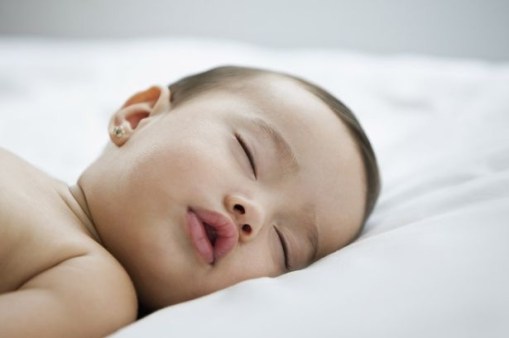 Baby-sleeping-on-bed
